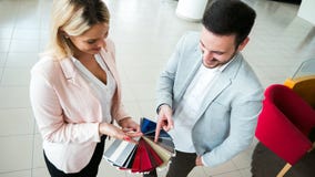Customer choosing a car color at dealership stock image Customer choosing a car color at dealership stock image