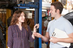 Customer Giving Car Keys To Garage Mechanic stock photos Customer Giving Car Keys To Garage Mechanic stock photos