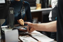 Customer paying via modern payment terminal using mobile phone. NFC payment. stock photos Customer paying via modern payment terminal using mobile phone. NFC payment. stock photos