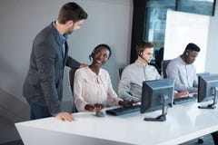 Customer service executive trainer monitoring her team royalty free stock images Customer service executive trainer monitoring her team royalty free stock images