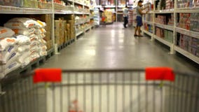 Customer shopping at supermarket with trolley. stock video footage Customer shopping at supermarket with trolley. stock video footage