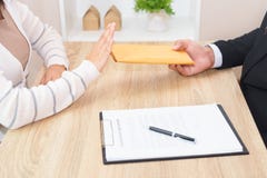 A Customer Woman rejecting money in envelope offered by business Stock Images A Customer Woman rejecting money in envelope offered by business Stock Images