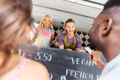 Customers giving credit card at food truck seller Royalty Free Stock Images Customers giving credit card at food truck seller Royalty Free Stock Images