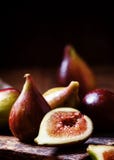 Cut Purple Figs On The Board. Vintage Wooden Background, Low Key Stock Photos