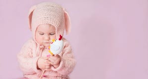 Cute adorable baby girl closeup portrait in knitted costume of E royalty free stock images Cute adorable baby girl closeup portrait in knitted costume of E royalty free stock images