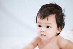 Cute asian baby girl wearing diaper lying on her stomach stock images Cute asian baby girl wearing diaper lying on her stomach stock images