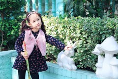 Cute Asian little beautiful girl play at autumn in the city park stock photo Cute Asian little beautiful girl play at autumn in the city park stock photo