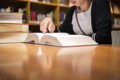 Cute Asian Woman Reading In A Bookstore, To Relax And Educate Herself Royalty Free Stock Photography Cute Asian Woman Reading In A Bookstore, To Relax And Educate Herself Royalty Free Stock Photography