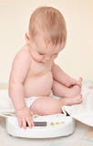 Cute Baby Check Own Weight Royalty Free Stock Image