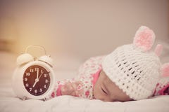 Cute Baby Girl And Alarm Clock Wake Up In The Morning Royalty Free Stock Photos
