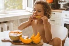 Cute Beautiful Little Boy Eating Fresh Melon. Royalty Free Stock Photos