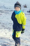 Cute boy play outdoors in snow. Happy boysl playing on a winter walk in nature royalty free stock photography Cute boy play outdoors in snow. Happy boysl playing on a winter walk in nature royalty free stock photography