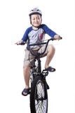 Cute boy riding a bike while wearing helmet Royalty Free Stock Image Cute boy riding a bike while wearing helmet Royalty Free Stock Image
