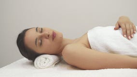 Girl shows her thumb up on the massage table royalty free stock photos Girl shows her thumb up on the massage table royalty free stock photos
