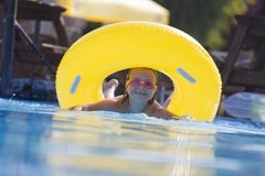 Cute child having some fun in swimming pool.