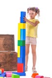 A cute child playing with toys. A creative girl with toy-blocks isolated on a white background. Education and development concept. royalty free stock photo A cute child playing with toys. A creative girl with toy-blocks isolated on a white background. Education and development concept. royalty free stock photo