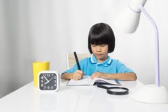 Cute Child Writing And Working On Work Desk. Stock Image