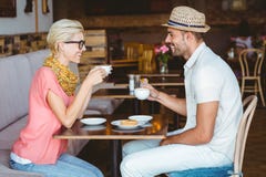 Cute couple on a date talking over a cup of coffee stock photo Cute couple on a date talking over a cup of coffee stock photo