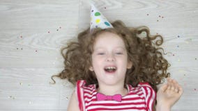 Cute curly girl playing and laughing in carnival party. High top view. Cute curly girl playing and laughing in carnival party Cute curly girl playing and laughing in carnival party. High top view. Cute curly girl playing and laughing in carnival party