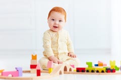 Cute ginger baby playing with toy railway road at home Royalty Free Stock Photo Cute ginger baby playing with toy railway road at home Royalty Free Stock Photo
