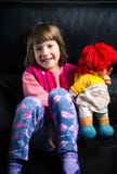 Cute girl with her toy on the sofa royalty free stock photo Cute girl with her toy on the sofa royalty free stock photo