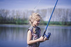 Cute Girl Holding A Fishing Rod Royalty Free Stock Photo
