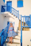 Cute Girl In Blue Dress At Street Of Typical Greek Traditional Village On Mykonos Island, In Greece Royalty Free Stock Photos