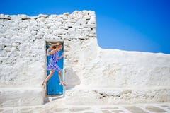 Cute Girl In Blue Dress Having Fun Outdoors Near Paraportiani Church. Kid At Street Of Typical Greek Traditional Village Royalty Free Stock Photography