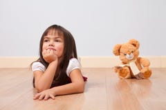 Cute Girl On A Wooden Floor Royalty Free Stock Photography