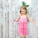 Cute girl playing with a city fountain royalty free stock images Cute girl playing with a city fountain royalty free stock images
