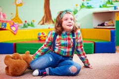 Cute girl playing in kindergarten for kids with special needs stock photos Cute girl playing in kindergarten for kids with special needs stock photos