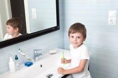 Cute healthy little child holding toothbrush in the bathroom royalty free stock image Cute healthy little child holding toothbrush in the bathroom royalty free stock image