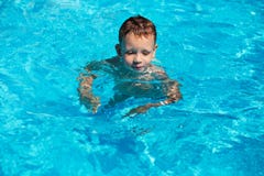 Cute kid, boy swimming in pool water Royalty Free Stock Photos Cute kid, boy swimming in pool water Royalty Free Stock Photos