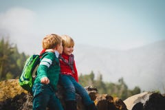 Cute kids -boy and girl -sharing a joke while travel in mountains stock photography Cute kids -boy and girl -sharing a joke while travel in mountains stock photography