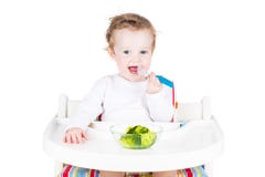 Cute little baby eating broccoli royalty free stock photography Cute little baby eating broccoli royalty free stock photography