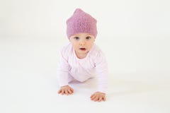 Cute little baby girl wearing hat sitting on floor. Photo of cute little baby girl wearing hat sitting on floor isolated over white background. Looking at camera Stock Image Cute little baby girl wearing hat sitting on floor. Photo of cute little baby girl wearing hat sitting on floor isolated over white background. Looking at camera Stock Image