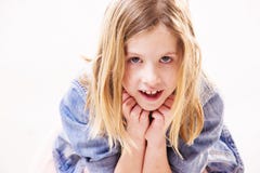 Cute little blonde girl is leaning on her hands while looking into the camera Stock Photography Cute little blonde girl is leaning on her hands while looking into the camera Stock Photography