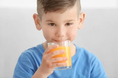 Cute little boy drinking juice at home Stock Photography Cute little boy drinking juice at home Stock Photography