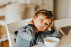 Cute little boy eating his cereals with milk stock images Cute little boy eating his cereals with milk stock images