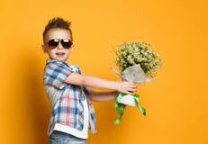 Cute little boy holding a bouquet of flowers. royalty free stock photography Cute little boy holding a bouquet of flowers. royalty free stock photography