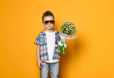 Cute little boy holding a bouquet of flowers. stock photography Cute little boy holding a bouquet of flowers. stock photography