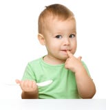 Cute little boy with spoon royalty free stock photos Cute little boy with spoon royalty free stock photos