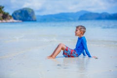 Cute little boy swimming on tropical beach royalty free stock image Cute little boy swimming on tropical beach royalty free stock image