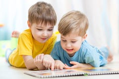 Cute little boys read book together stock image Cute little boys read book together stock image