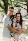 Cute little daughter and her young parents stock photos Cute little daughter and her young parents stock photos