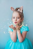 Cute little girl blowing magical dust. Royalty Free Stock Photo Cute little girl blowing magical dust. Royalty Free Stock Photo