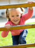 Cute little girl is climbing up on ladder royalty free stock photos Cute little girl is climbing up on ladder royalty free stock photos