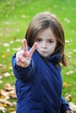 Little girl making victory sign stock image Little girl making victory sign stock image
