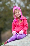 Cute little girl in pink sitting on hay bale. royalty free stock image Cute little girl in pink sitting on hay bale. royalty free stock image