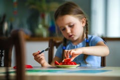 Cute little girl tasting strawberry at home stock image Cute little girl tasting strawberry at home stock image